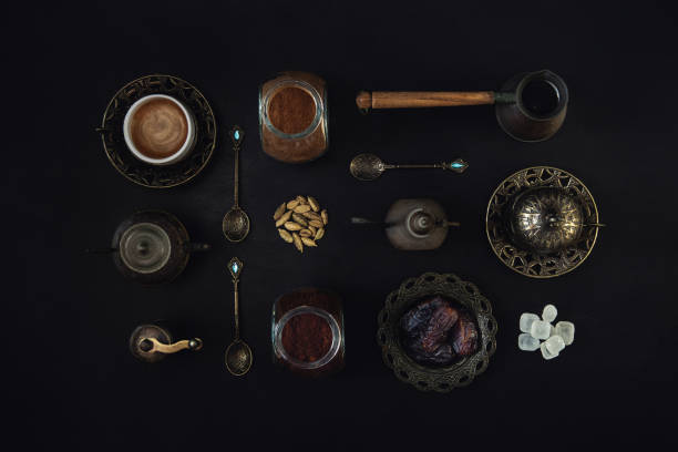 Detail of a coffee drink oriental style. Coffee table concept background photography inspired by turkish and arabic coffee drinking tradition. Flat lay of Turkish coffee, arabic spices, dates, coffee utensils and accessories. Detail of a coffee drink oriental style. coffee table top stock pictures, royalty-free photos & images