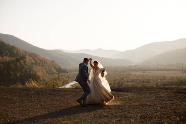 Wedding photo session of the bride and groom in the mountains. Photoshoot at sunset. stock photo