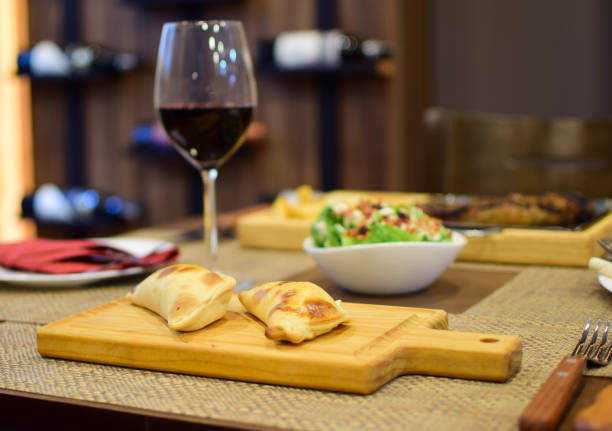 argentine empanadas with wooden background and green salad - salad food and drink food lettuce imagens e fotografias de stock