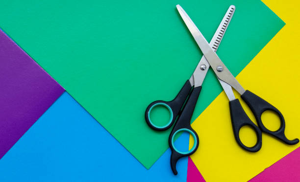 istock Hair cutting scissors. Thinning scissors. Top view of scissors isolated on a colored background. 1221000483
