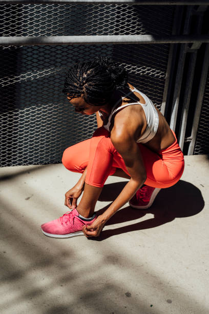 istock African Sportswoman Tying Shoelace 1221001593