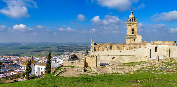 Panoramic view of Medina Sidonia castle ruins, Santa Maria church and the Roman archaeological site with the white town in the background.