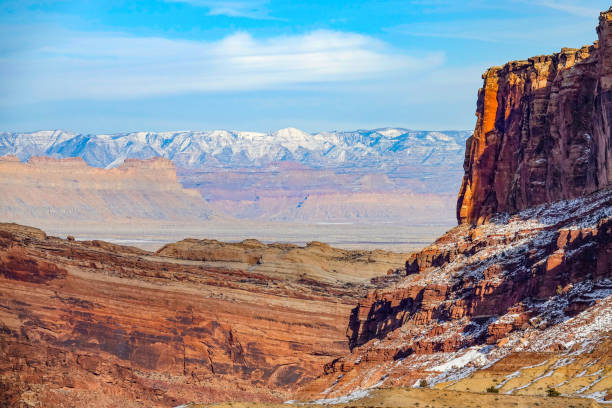 istock drone: breathtaking flying view snowy mountain range behind a red rocky cliff. 1221005423