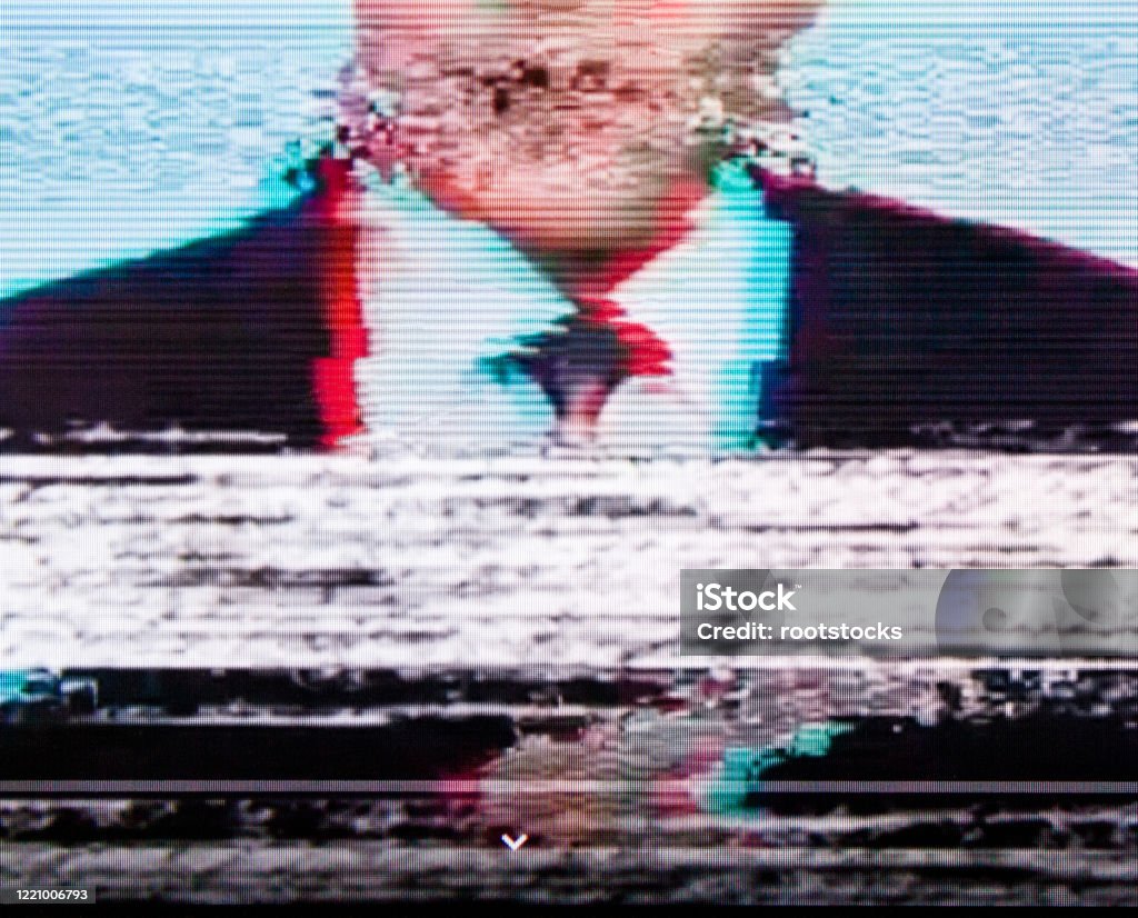 Man in a suit on the screen. Glitch. Man in a suit on the screen. Broadcaster. Glitch. Digital errors on the screen. Television Set Stock Photo