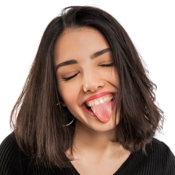 istock Young woman showing tongue 1221009171