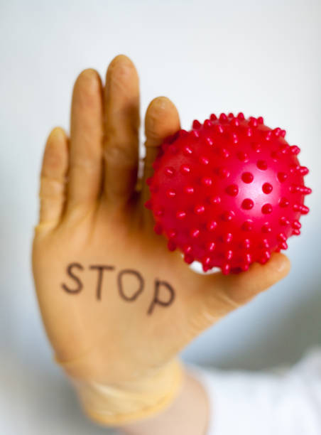 istock Stop Covid-19. Text on medical glove. 1221010025