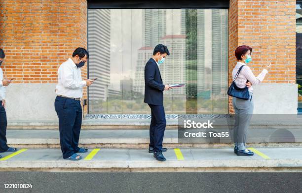 Asian People Wearing Mask And Keep Social Distancing To Avoid The Spread Of Covid19 Stock Photo - Download Image Now