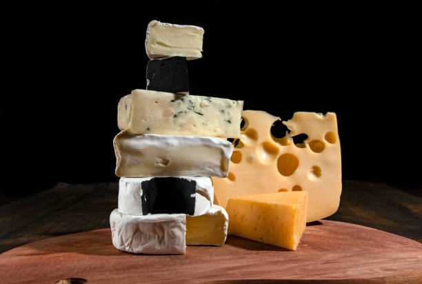 istock Various types of cheese on a rustic wooden table Different types of cheeses on a black background. 1221011078