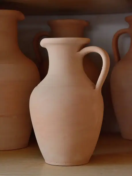 Ceramic craft jug made by a Potter, against the background of other clay products