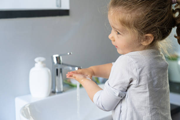 istock little girl washing her hands 1221012764
