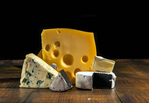 istock Various types of cheese on a rustic wooden table Different types of cheeses on a black background. 1221013825