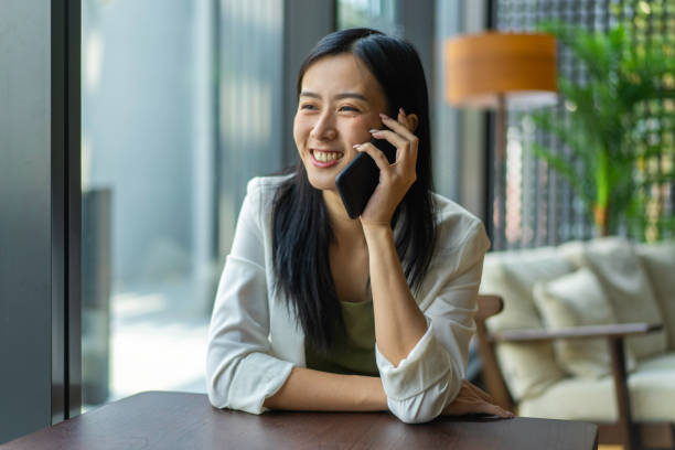 istock Young Asian woman taking a call on her mobile phone. 1221014324