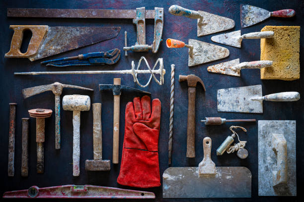 Wooden wall full of hammer, pliers, scissors and other tools. Creative workshop