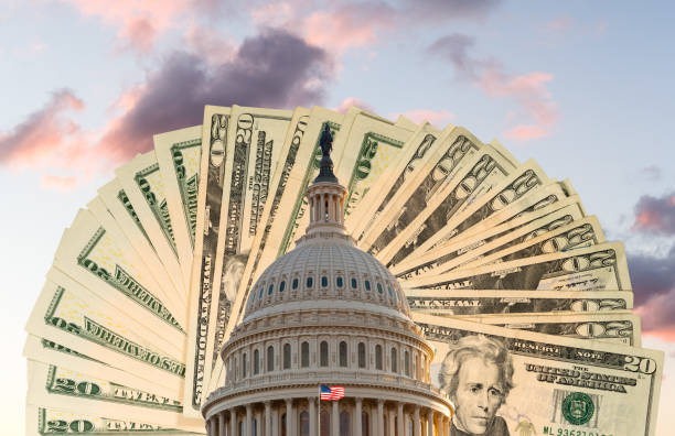 flag flies in front of capitol in dc with cash behind the dome as concept for stimulus virus payment - washington dc architecture nobody american flag imagens e fotografias de stock