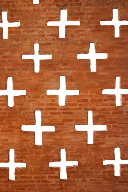 Brick wall with multiple plus-shaped holes on it. Transparent background.
