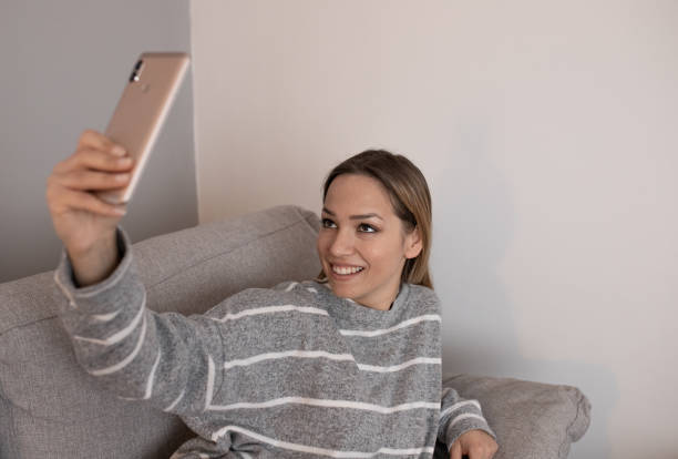 istock Young attractive woman taking selfie at home 1221027061