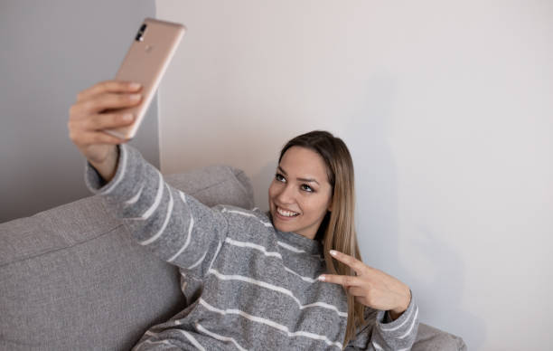 istock Young attractive woman taking selfie at home 1221027148