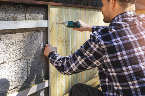 istock installing wooden planks on concrete block wall at home backyard 1221027458