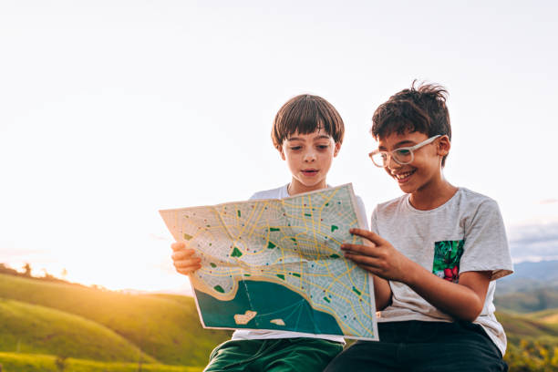 Two kids looking at map outdoors