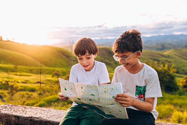 istock Two kids looking at map outdoors 1221028968