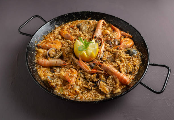 istock Spanish seafood paella with rustic dark background 1221029213