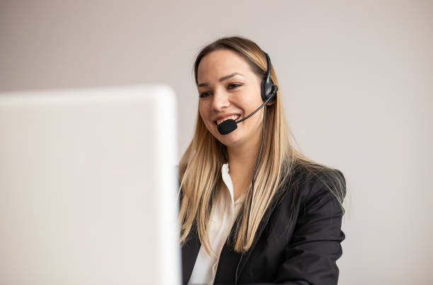 istock Young woman working in call center. Customer support woman in office 1221029521
