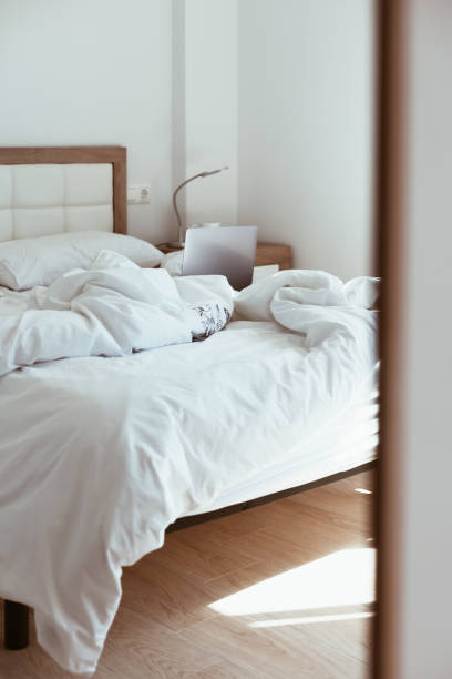 istock Working home isolation concept. Laptop in bed 1221030037