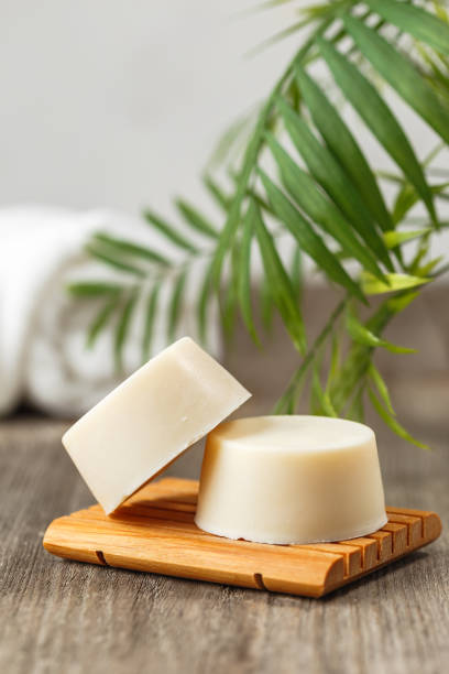 istock Eco friendly solid shampoo soap bar on wooden dish 1221030130