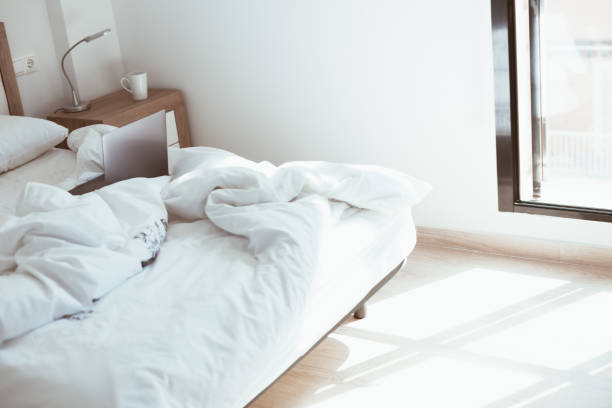 istock Working home isolation concept. Laptop in bed 1221030136
