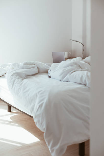 istock Working home isolation concept. Laptop in bed 1221030174