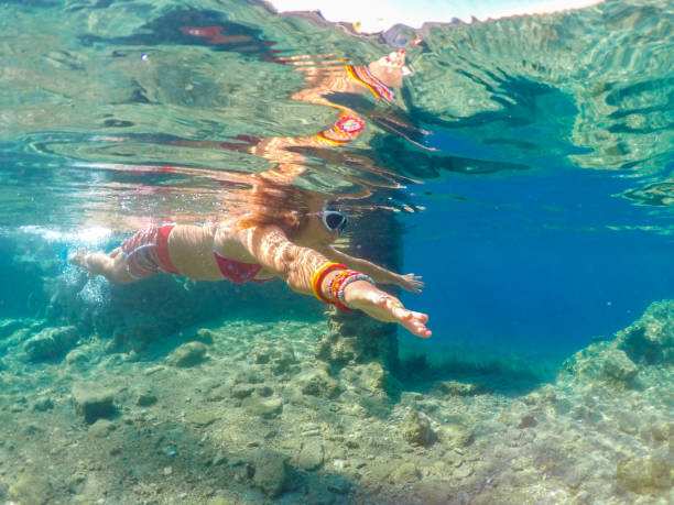istock Woman floating in the clean sea. 1221032476