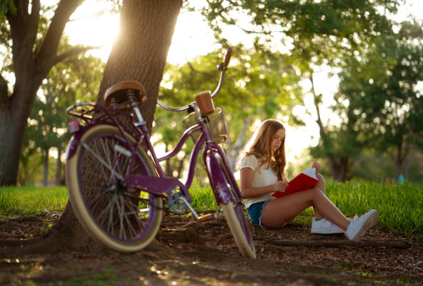 Teen reading in the park