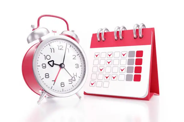 An alarm clock placed beside of a desk calendar with printed symbolic days of a month and both of them are standing on reflective white background. 3D rendering graphics.