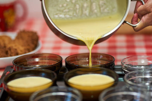 Pouring creme brulee cream into small bowls