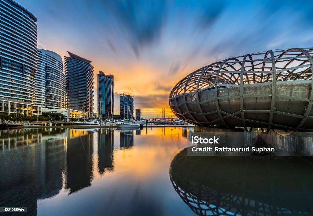 Stunning Architecture Bridge in Melbourne, Webb Bridge, Capital City Trail The Stunning Architecture Bridge (Webb Bridge) on Yarra River. Once Capital City Trail in Melbourne City. View face to port in Yarra River and skyscraper background with twilight sky sunset in winter, Melbourne, Victoria, Australia Melbourne - Australia Stock Photo