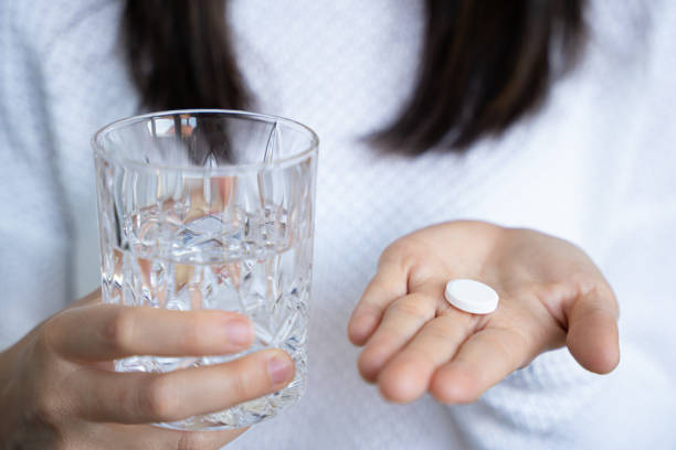 istock person taking a medical pill 1221036166