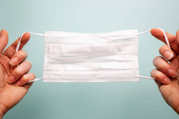 istock Hand holding medical mask 1221036410