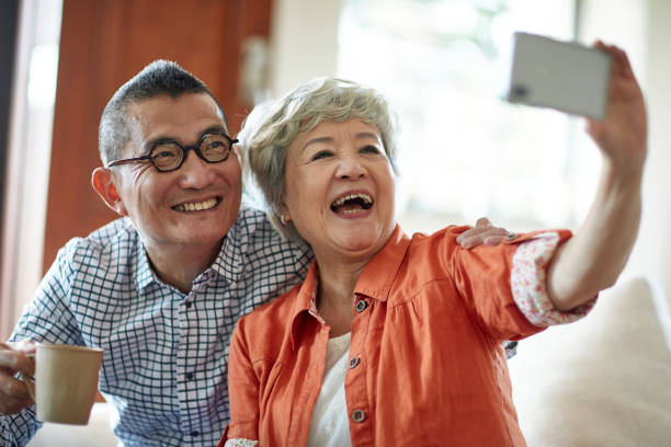 istock Chinese Seniors Taking Selfie While Enjoying Morning Coffee 1221036713
