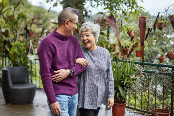 istock Smiling Chinese Seniors Walking Outdoors Arm in Arm 1221036727