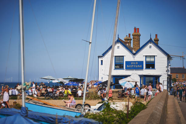 Whitstable, UK - August, 2019. A crowded beach with a local pub during the Summer Bank Holiday.