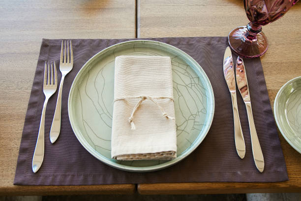 istock Table setting for a banquet. Beautiful turquoise plate with forks and knives 1221038744