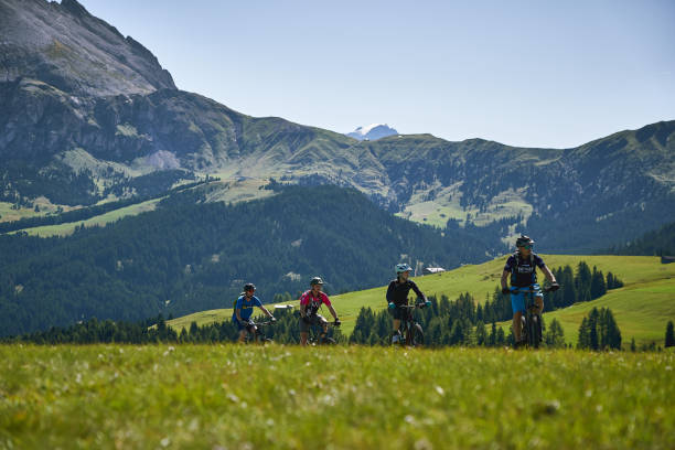 Tourists mountain biking on the Seiser Alm (Alpe di Siusi in Italian) during Summer. Seiser Alm, Italy - September,  2019. Tourists mountain biking on the Seiser Alm (Alpe di Siusi in Italian) during Summer. trentino south tyrol stock pictures, royalty-free photos & images