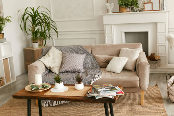 istock Luxurious living room with a soft, comfortable sofa. White artificial fireplace in the interior. 1221039896