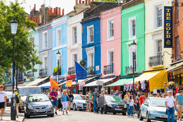 Neighborhood of Notting Hill Portobello road street and colorful multicolored famous architecture London, UK - June 24, 2018: Neighborhood of Notting Hill Portobello road street and colorful multicolored famous style architecture with people shopping notting hill stock pictures, royalty-free photos & images