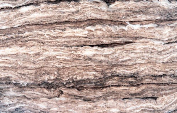 istock Thermal insulation material, rock wool. Thermal roof insulation layer. Mineral wool or mineral fiber, mineral cotton, mineral fibre, glass wool, MMMF, MMVF. Fiber thermal insulation close-up. 1221040519