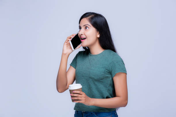 istock Girl with mobile phone at white background 1221040533