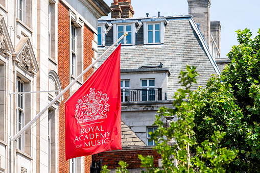 London, UK - June 24, 2018: The Royal Academy of Music institution architecture building exterior and red banner in Marylebone