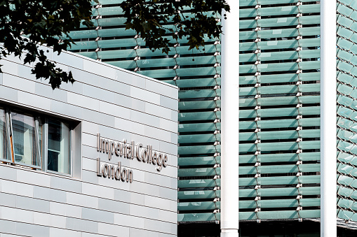 London, UK - June 24, 2018: Imperial College modern sign closeup of building in summer and nobody with contemporary architecture of university