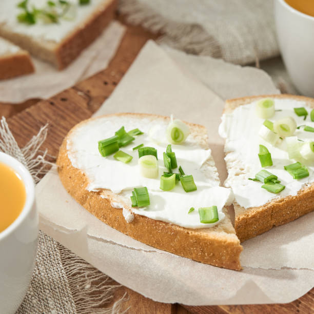 istock Two sandwiches heart shaped with cream cheese and green onion. 1221041981