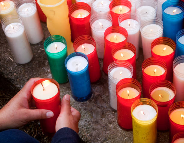 istock Group of multi colored candles, woman's hand holding one of them. 1221042144